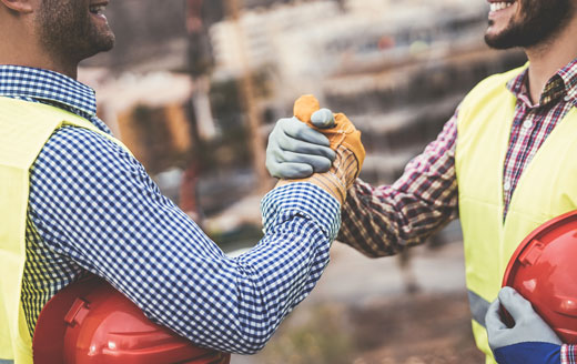 young-builders-shaking-hands-making-an-agreement